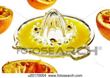 Picture - Orange halves and glass juicer. Fotosearch