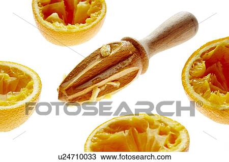 Stock Image - Orange halves and wooden juicer. Fotosearch