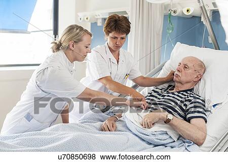 Stock Photo - Patient with nurses. Fotosearch