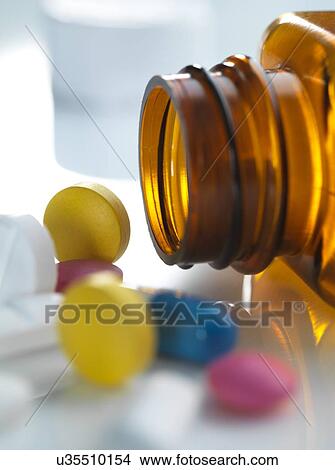 Pills spilling out of a bottle View Large Photo Image Picture - Pills spilling out of a bottle. Fotosearch
