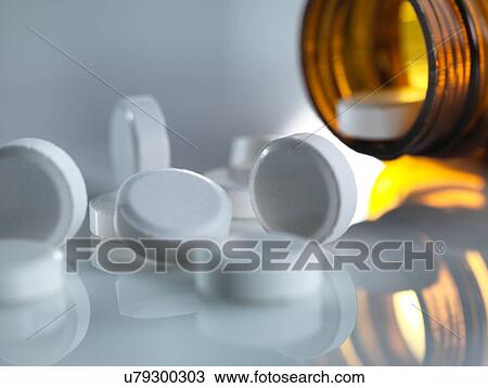 Stock Image - Pills spilling out of a bottle. Fotosearch