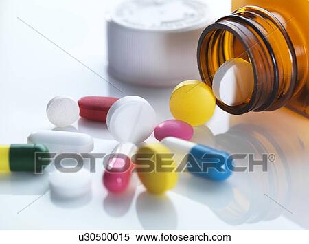 Pills spilling out of a bottle View Large Photo Image Stock Photography - Pills spilling out of a bottle. Fotosearch