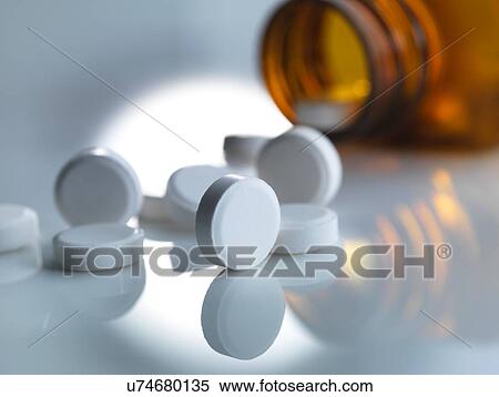 Pills spilling out of a bottle View Large Photo Image Stock Photography - Pills spilling out of a bottle. Fotosearch