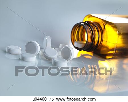 Stock Photography - Pills spilling out of a bottle. Fotosearch