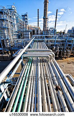 Stock Photo - Pipelines at oil and gas refinery. Fotosearch