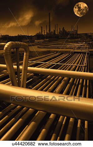 Stock Image - Pipes on petrochemical plant with moon. Fotosearch