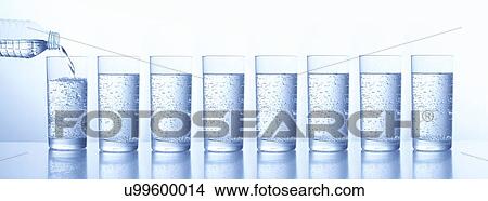 Picture - Pouring water in glasses. Fotosearch