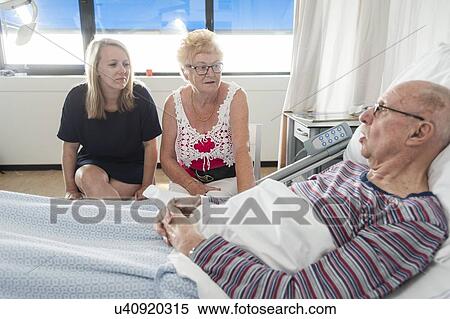 Senior man with two female visitors View Large Photo Image Stock Photography - Senior man with two female visitors. Fotosearch