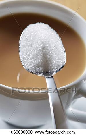 Stock Image - Spoonful of sugar and hot drink. Fotosearch