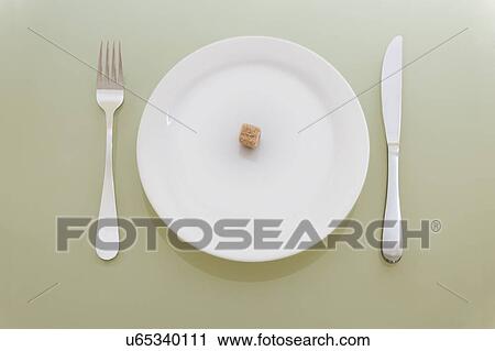 Stock Image - Sugarlump on dinner plate, studio shot. Fotosearch