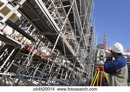 Picture - Surveyor working on construction site. Fotosearch