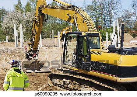 Surveyor working on construction site View Large Photo Image Stock Photography - Surveyor working on construction site. Fotosearch