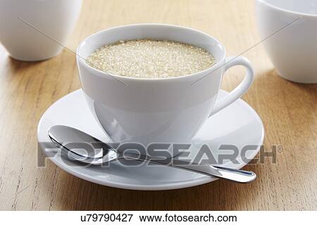 Stock Photo - Tea cup full of sugar. Fotosearch