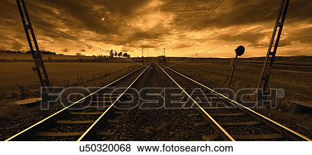 Stock Photo - Train track at sunset. Fotosearch