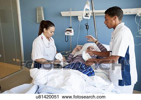 Two nurses fastening medical restraint View Large Photo Image Stock Image - Two nurses fastening medical restraint. Fotosearch