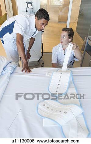 Two nurses fastening medical restraint View Large Photo Image Stock Photograph - Two nurses fastening medical restraint. Fotosearch