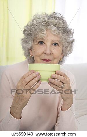 Woman holding bowl View Large Photo Image Stock Image - Woman holding bowl. Fotosearch