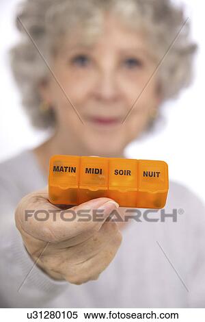 Woman holding pill organiser View Large Photo Image Stock Photography - Woman holding pill organiser. Fotosearch