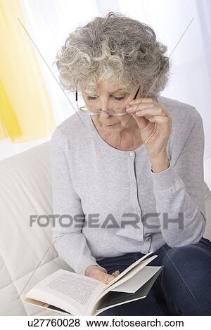 Woman reading book wearing glasses View Large Photo Image Stock Photo - Woman reading book wearing glasses. Fotosearch