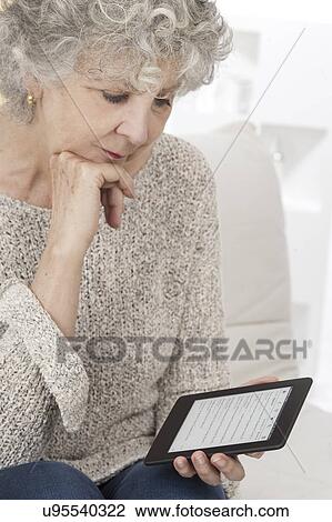Woman reading ebook View Large Photo Image Stock Image - Woman reading ebook. Fotosearch