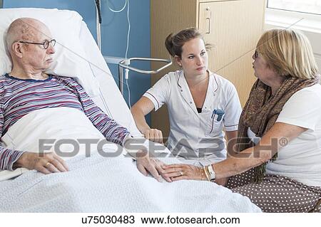 Woman visiting senior man talking to nurse View Large Photo Image Stock Image - Woman visiting senior man talking to nurse. Fotosearch