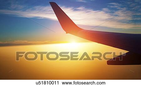 Aeroplane wing at sunset View Large Photo Image Stock Image - Aeroplane wing at sunset. Fotosearch
