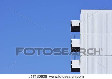 Apartment building against clear blue sky View Large Photo Image Stock Photography - Apartment building against clear blue sky. Fotosearch