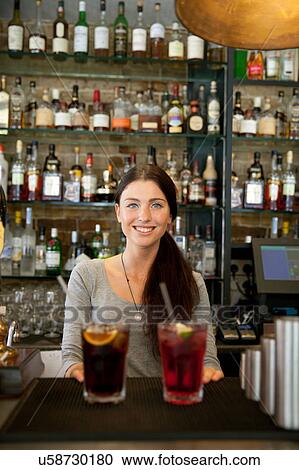 Bartender serving drinks in pub, London View Large Photo Image Stock Image - Bartender serving drinks in pub, London. Fotosearch