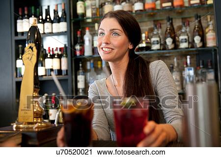 Bartender serving drinks in pub, London View Large Photo Image Stock Image - Bartender serving drinks in pub, London. Fotosearch
