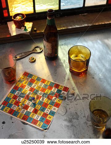 Beer bottle and glasses with board game on pub table View Large Photo Image Stock Photo - Beer bottle and glasses with board game on pub table. Fotosearch