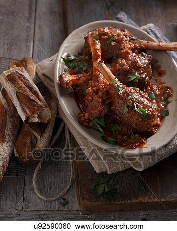 Bistro meal of lamb shanks in red wine on table View Large Photo Image Stock Image - Bistro meal of lamb shanks in red wine on table. Fotosearch