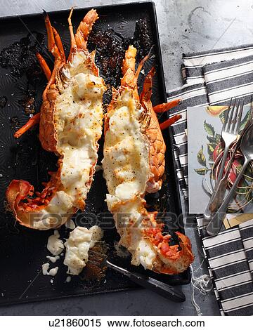 Stock Photography - Bistro meal of lobster thermidor on table. Fotosearch