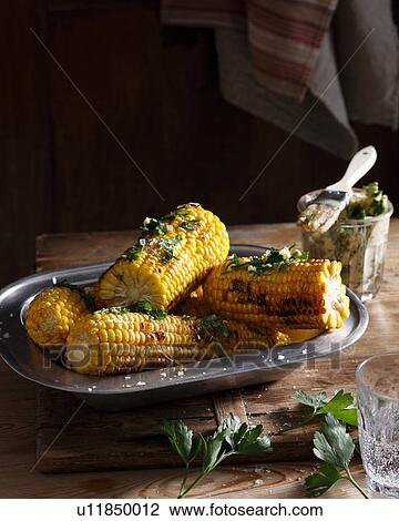 Bistro table with dish of corn on the cob and herb butter View Large Photo Image Stock Image - Bistro table with dish of corn on the cob and herb butter. Fotosearch