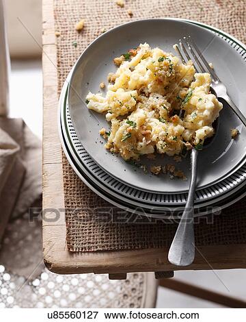 Bistro table with stacked plates and macaroni cheese View Large Photo Image Stock Photo - Bistro table with stacked plates and macaroni cheese. Fotosearch