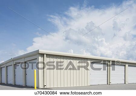 Picture - Blue sky over distribution warehouse. Fotosearch