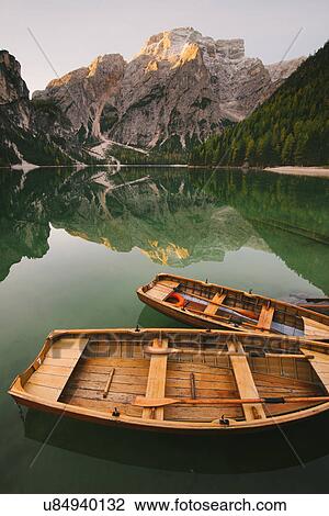 Stock Image - Boats moored at Lago di Braies, Dolomite Alps, Val di Braies, South Tyrol, Italy. Fotosearch