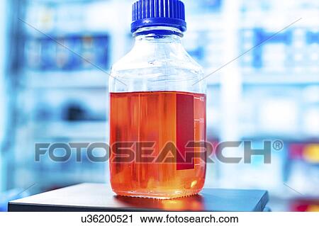 Bottle containing red liquid View Large Photo Image Stock Image - Bottle containing red liquid. Fotosearch