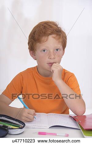 Stock Image - Boy doing homework. Fotosearch