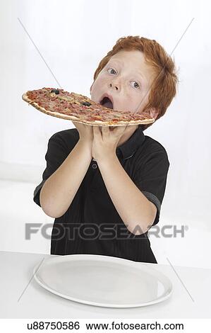 Boy eating large pizza View Large Photo Image Stock Photograph - Boy eating large pizza. Fotosearch
