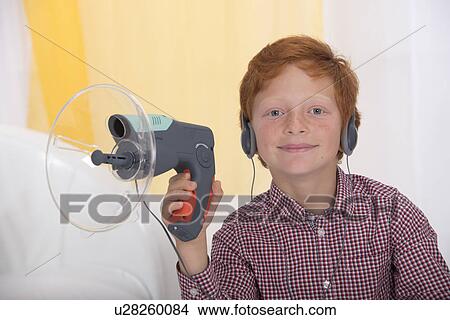 Picture - Boy playing with spy device. Fotosearch