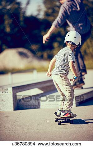 Boy skateboarding in park View Large Photo Image Picture - Boy skateboarding in park. Fotosearch