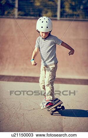 Boy skateboarding in park View Large Photo Image Stock Image - Boy skateboarding in park. Fotosearch