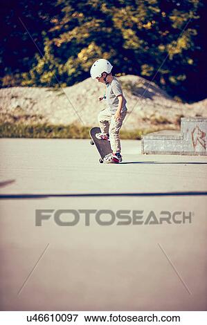 Stock Photo - Boy skateboarding in park. Fotosearch