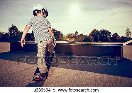 Stock Photography - Boy skateboarding in park. Fotosearch