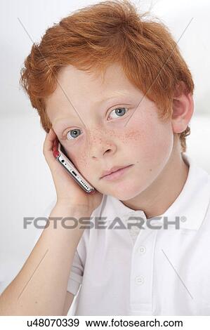 Stock Photo - Boy using cell phone. Fotosearch