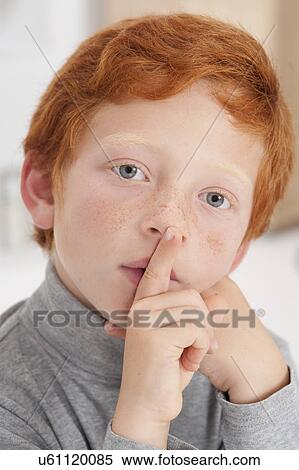 Boy with finger on lips View Large Photo Image Stock Photography - Boy with finger on lips. Fotosearch