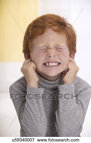 Boy with fingers in his ears View Large Photo Image Stock Photo - Boy with fingers in his ears. Fotosearch