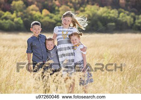 Boys and girls (4-5, 6-7, 8-9) standing in field, embracing View Large Photo Image Stock Photograph - Boys and girls (4-5, 6-7, 8-9) standing in field, embracing. Fotosearch