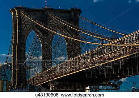 Stock Photograph - Brooklyn Bridge at sunset, NY NY - in black and white. Fotosearch
