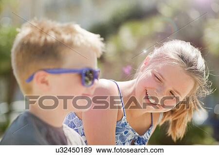 Stock Photo - Brother and sister laughing together. Fotosearch